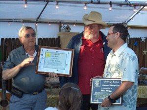 Jack Jekowski (left) and Kim Johnson (middle) present a CESE award to treasurer Steve Brügge